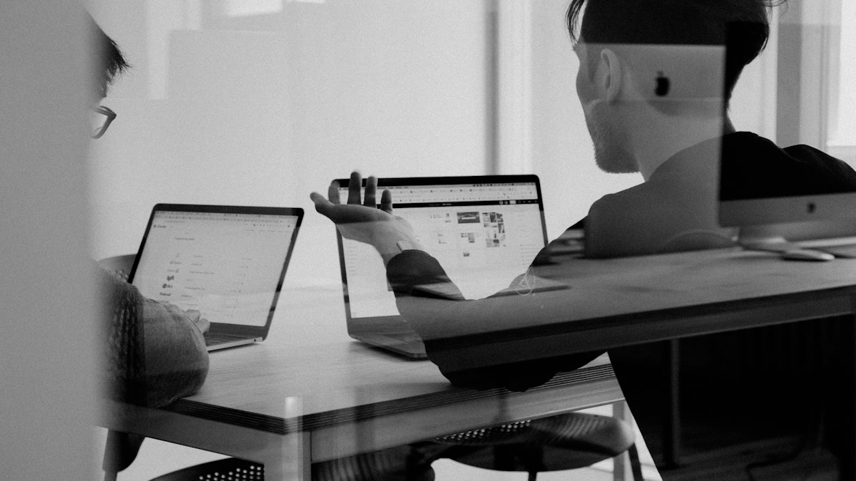 People working at laptops in a bright office