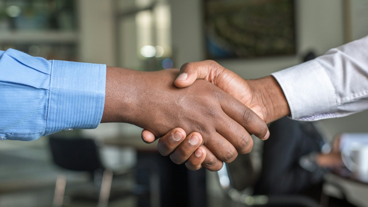 Two people shaking hands after a successful meeting
